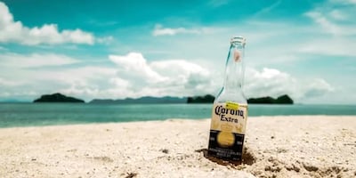 Image of a beer bottle on the beach