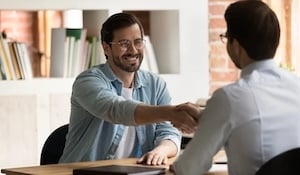 employee shakes boss' hand
