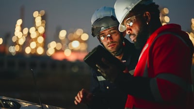 Team Inspection engineers working with laptop of oil factory and gas refinery plant industry at night for inspector safety quality control. 