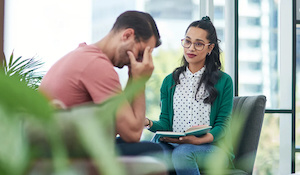 Image of a worker consoling a coworker